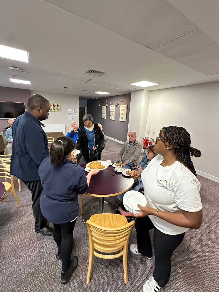 Learner serving the community at an enterprise café event